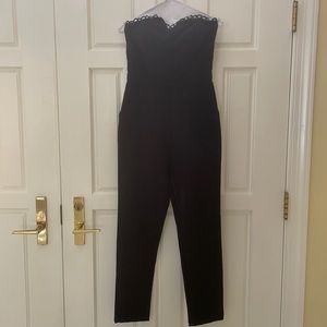 Black jumpsuit with lace details and pockets!